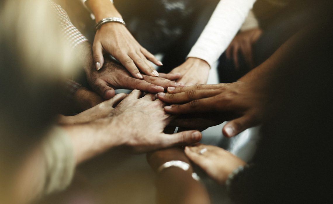 Closeup of diverse people joining their hands